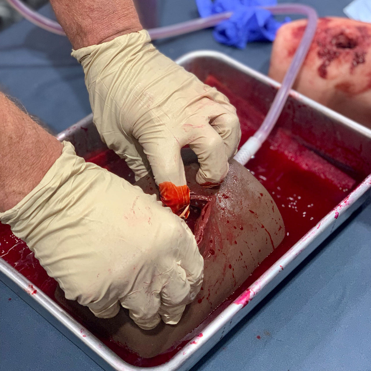 Dark Tone TrueClot® Wound Packing Task Trainer, In use