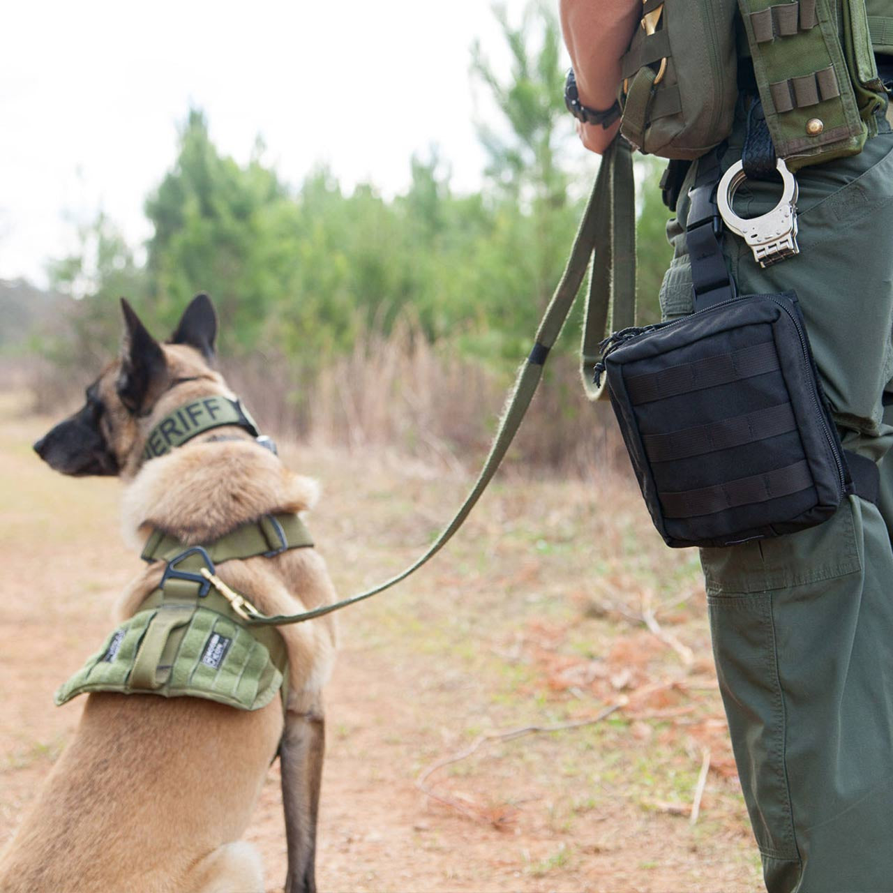 K9 Handler Trauma Kit by TacMed Solutions mounted on thigh rig in field