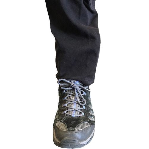 Rescue Essentials Tactical Ankle Medical Kit by rescue essentials shown with medical products in it mounted on an ankle concealed by cargo pants