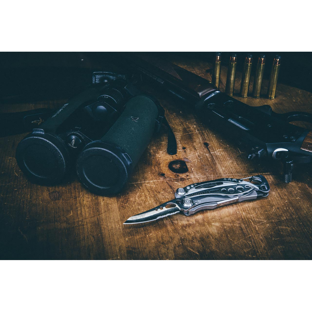 Leatherman Skeletool CX, with gun and binoculars