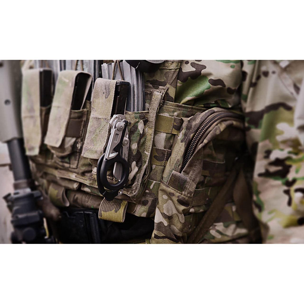 Leatherman RAPTOR Emergency Medical Tool with black handle mounted on ammo vest