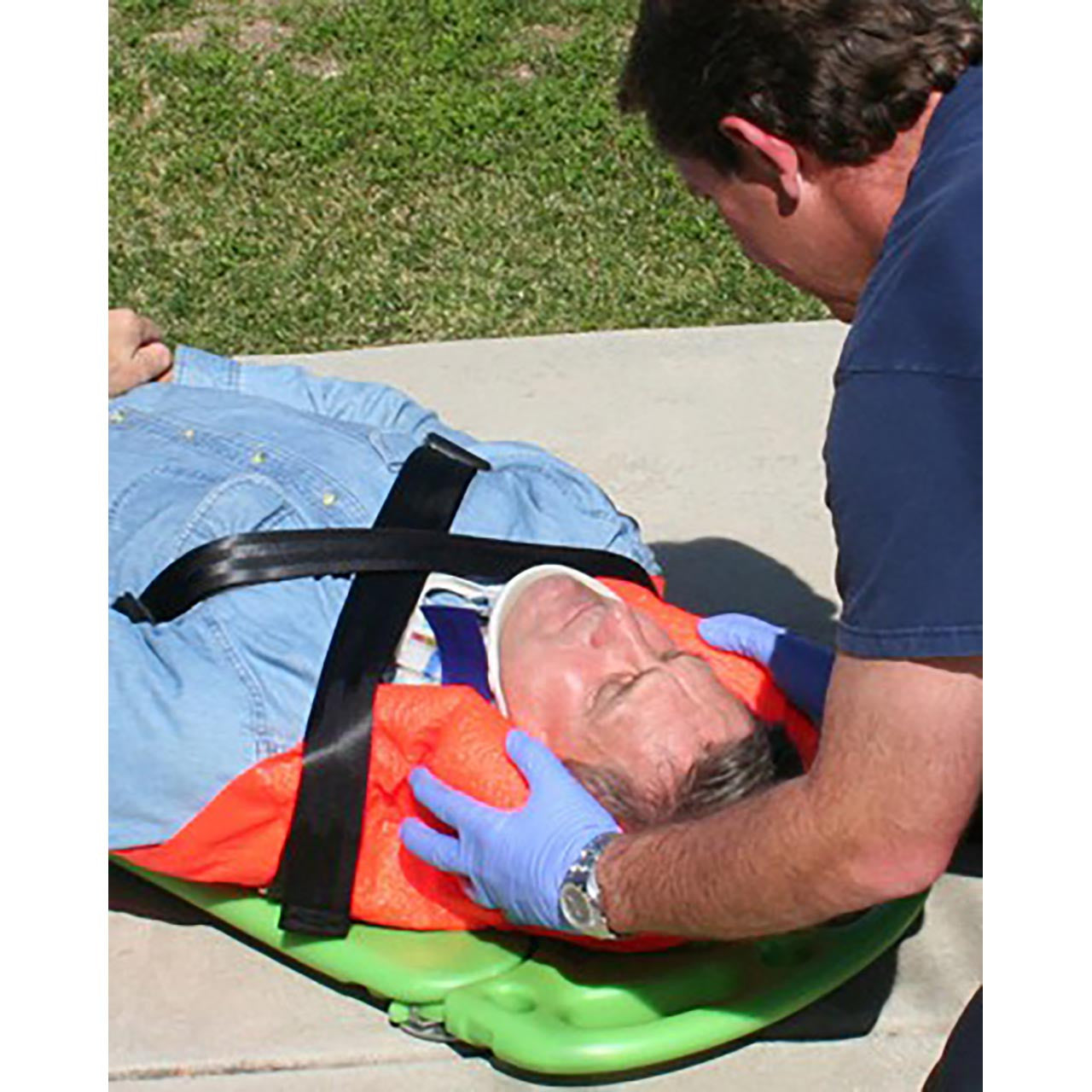 CombiCarrier in use, stabilizing patient's head and neck while and securing patient to board