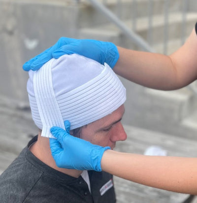 Rescue Essentials Trauma Cap, being put on