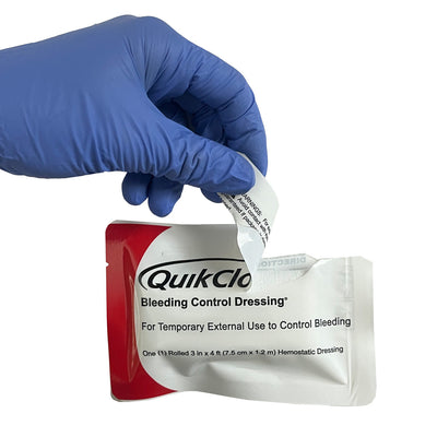 QuikClot® Bleeding Control Dressing, being opened