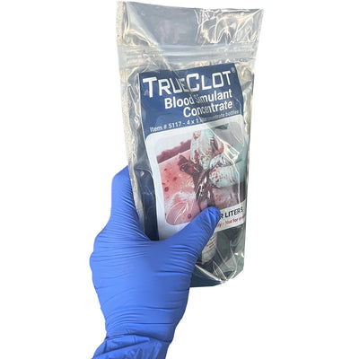 TrueClot® Blood Simulant Concentrate, in packaging (in hand)