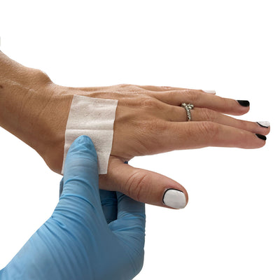 Sting Relief Wipe, in use on hand