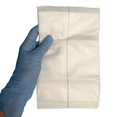 Combine ABD Pad, unfolded in hand