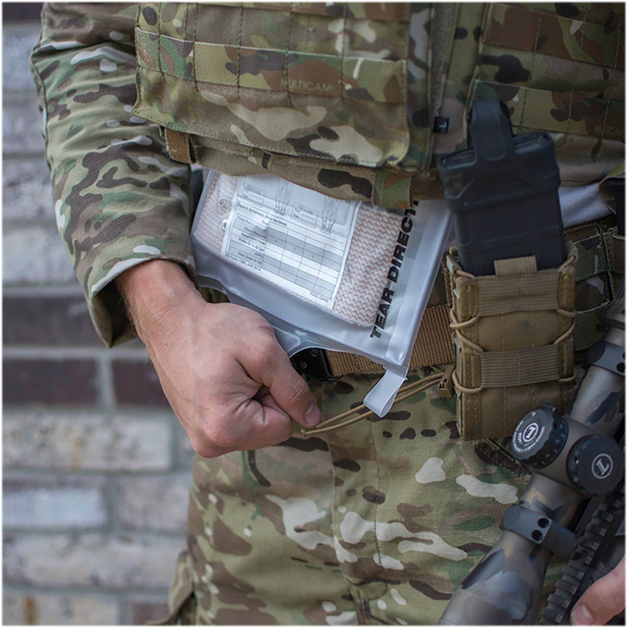 Deployment Trauma Kit II with External Pill Pouch by Phokus Research, being pulled from under armor