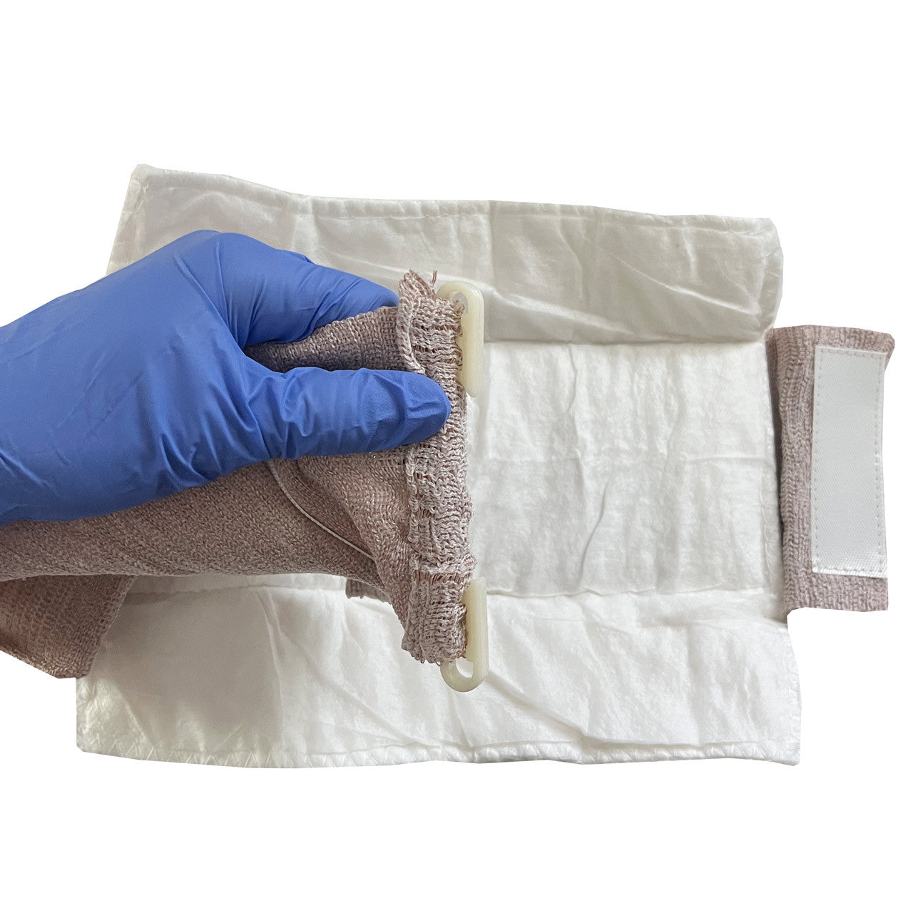 Emergency Trauma Dressing, being unfolded