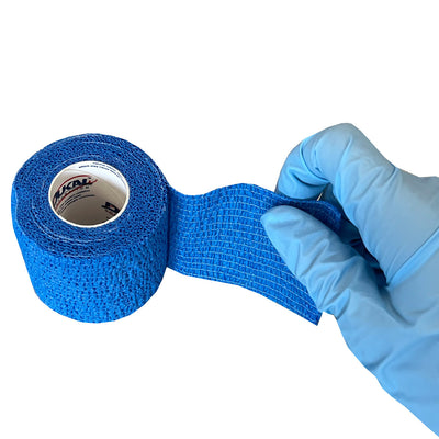 Blue Cohesive Wrap, being unwrapped