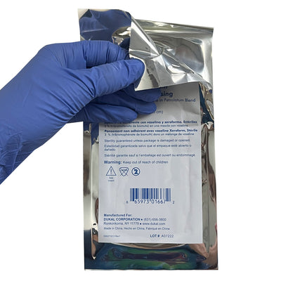 5" x 9" Petrolatum Impregnated Gauze Dressing, being opened