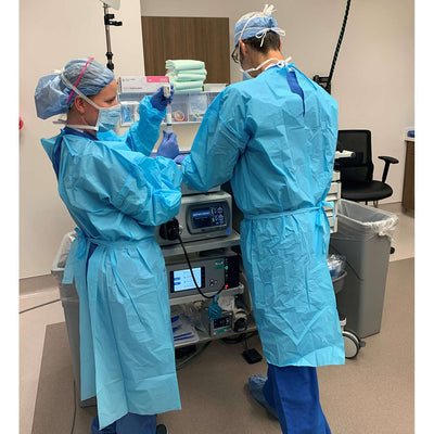 Disposable Fluid Resistant Gown shown in hospital lab setting