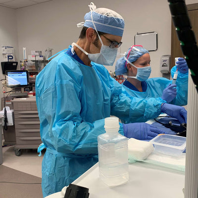 Disposable Fluid Resistant Gown shown in lab setting