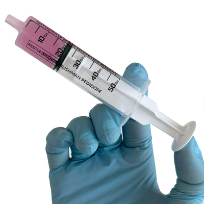 Slishman Pedidose Pediatric Dosing Syringe, in hand with medicine  