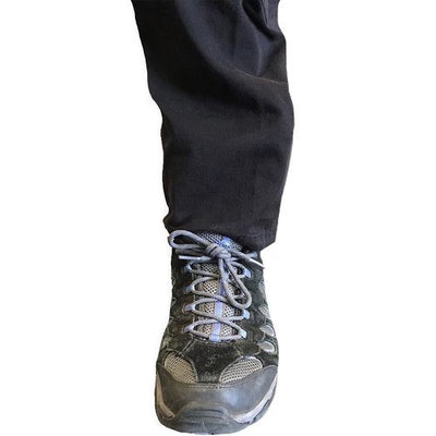 Rescue Essentials Tactical Ankle Medical Kit by rescue essentials shown with medical products in it mounted on an ankle concealed by cargo pants