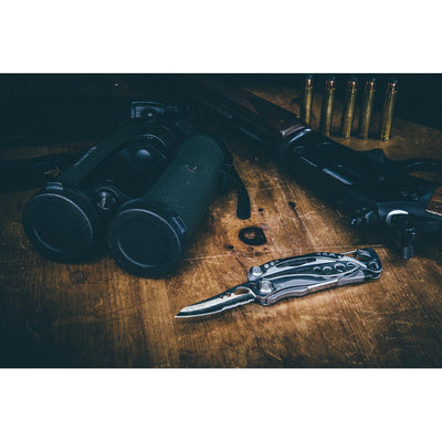 Leatherman Skeletool CX, with gun and binoculars