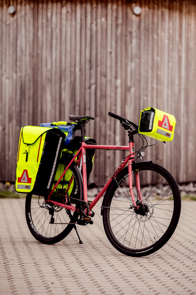 Yellow PAX bicycle bag on side of bike, front angle