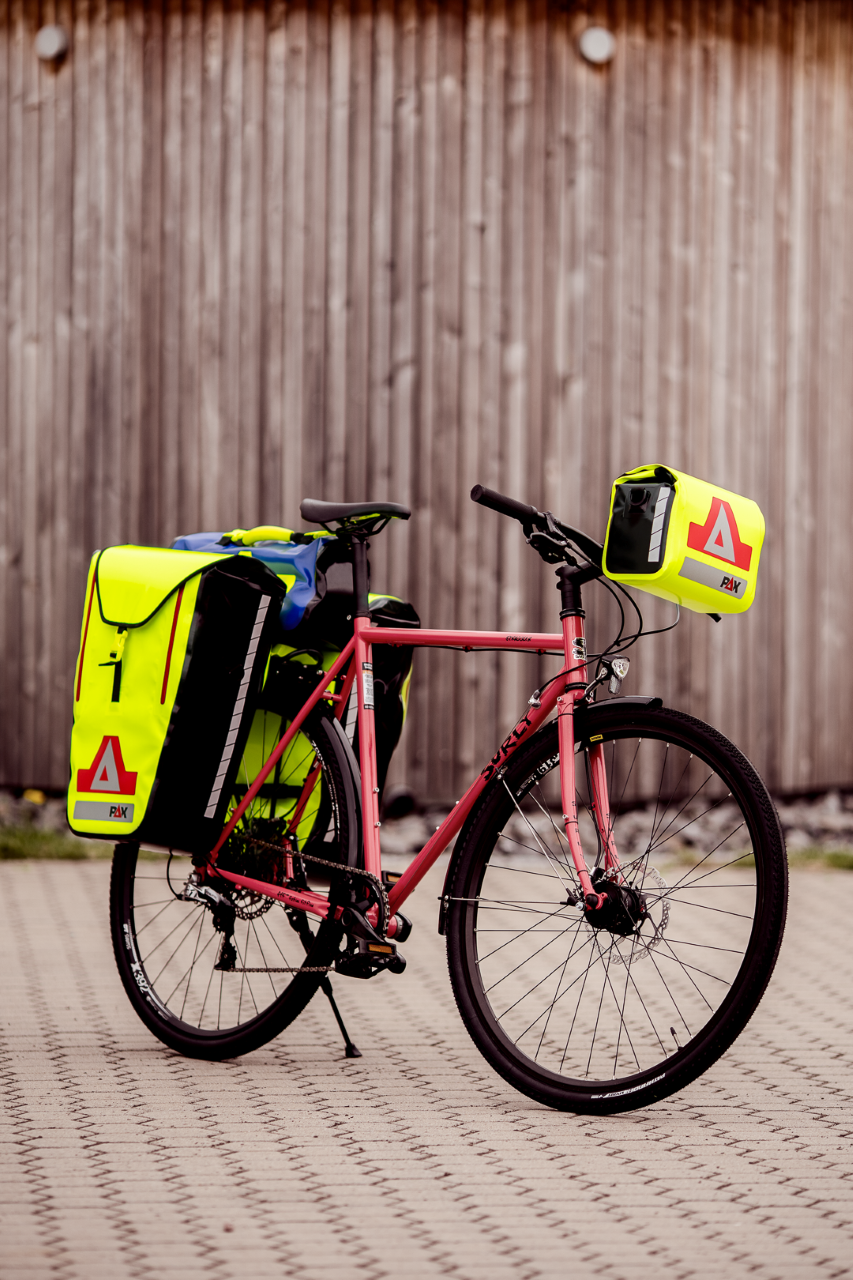 Yellow PAX bicycle bag on side of bike, front angle