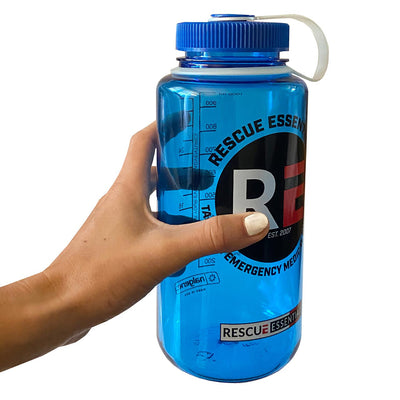 Rescue Essentials Wide Mouth Nalgene Bottle, blue and white lid, in hand