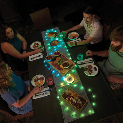 Radiant® StarLit™ Rechargeable Lantern + String Light, in use on table