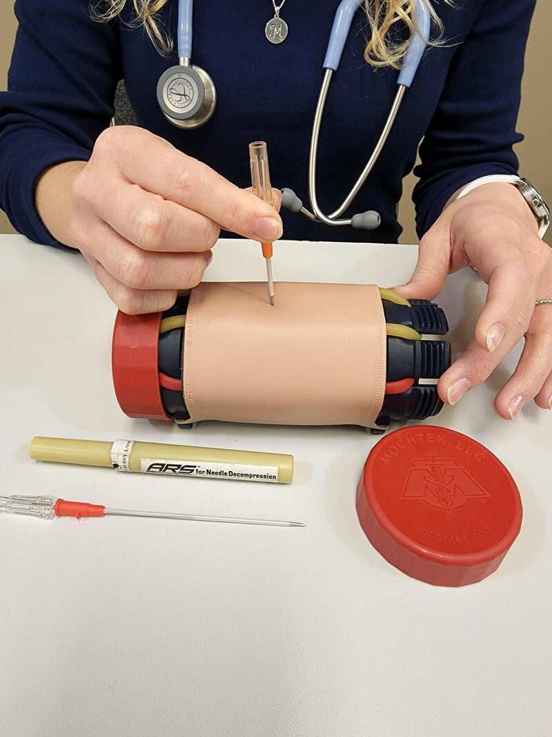 Multi-Insertion Training System (M.I.T.S.) Composite Trainer Kit, In use training on needle decompression